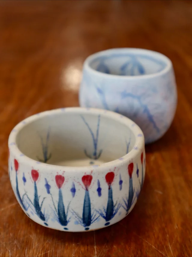 These gorgeous little thrown pots made by Sammy and decorated in a folk art style (our current class theme). Experimenting with a range of materials to get these effects, the brighter piece is underglaze and underglaze pencil, the lighter one in stains. 
So beautiful!