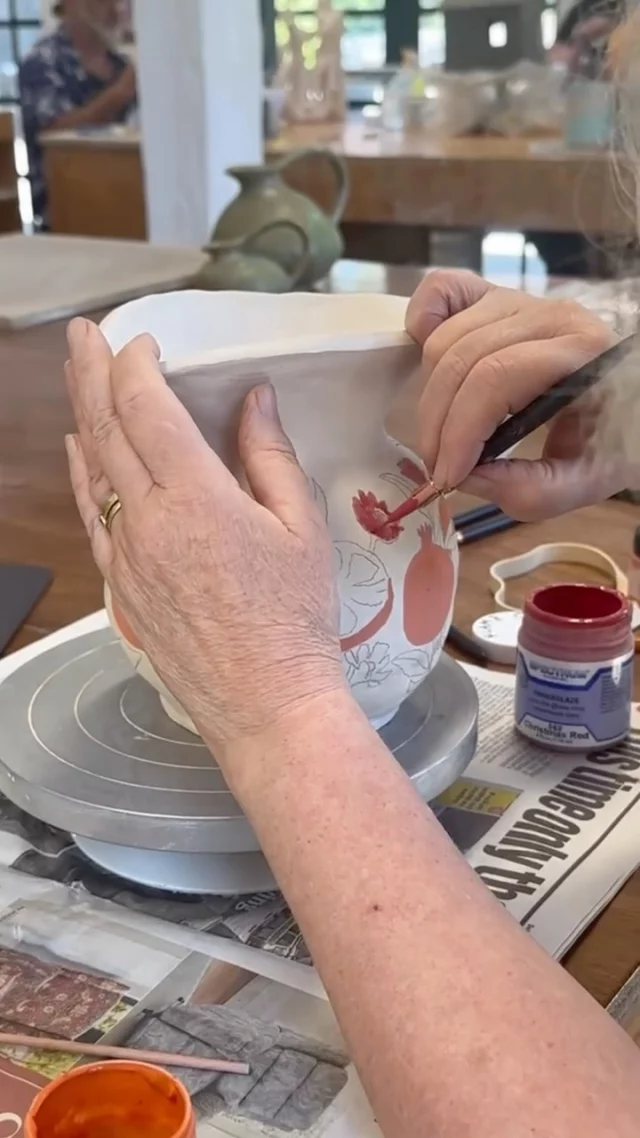 A hand-coiled pitcher painted with pomegranates. 
When you work with clay not only do you get the opportunity to play with the material itself, but also enjoy the decorating part. In this case botanical painting using underglazes. 
#potteryclasses #underglazes